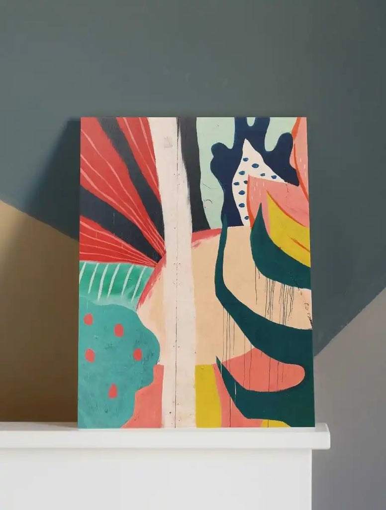 Abstract art piece featuring bold curved shapes in coral, turquoise, navy, and yellow colors on a light wooden panel.